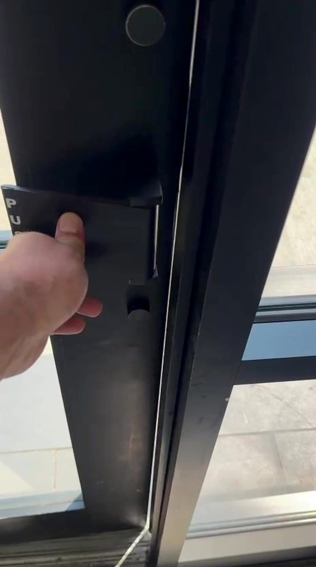 New pull paddle assembly on an aluminum storefront door